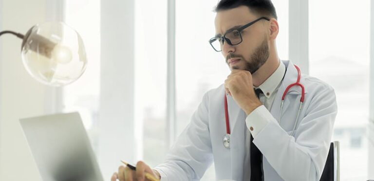 physician looks over data in a healthcare analytics tool