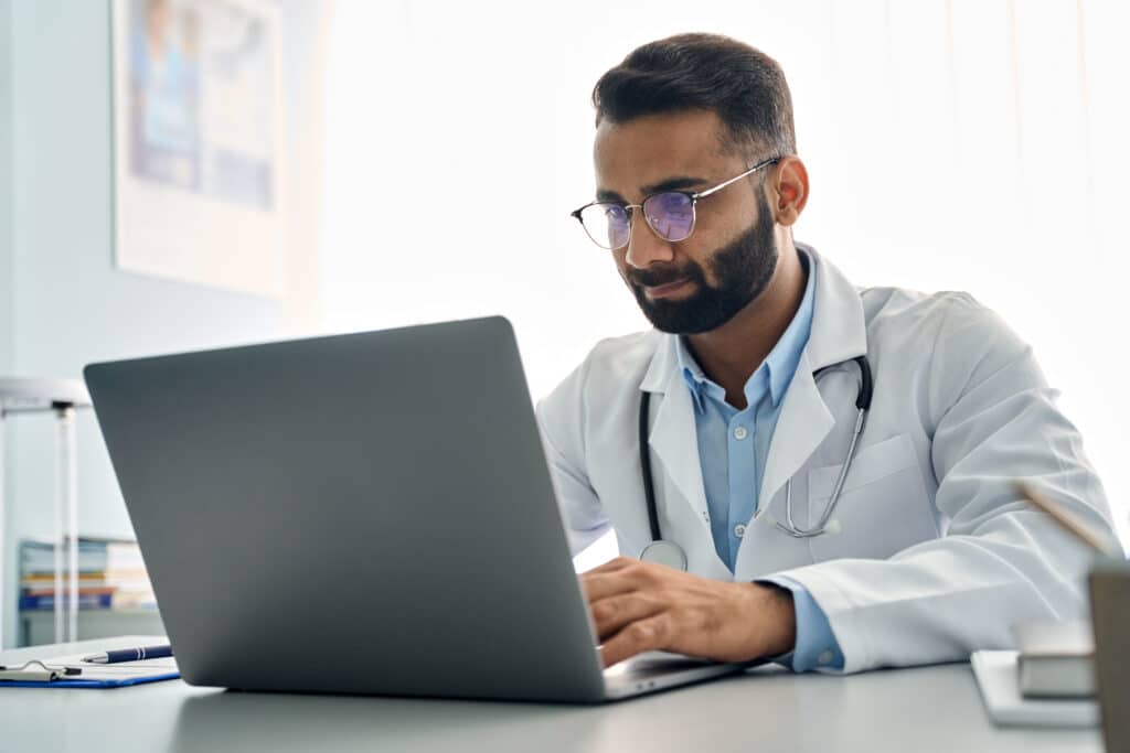 a doctor looks over patient records in a specialized EHR