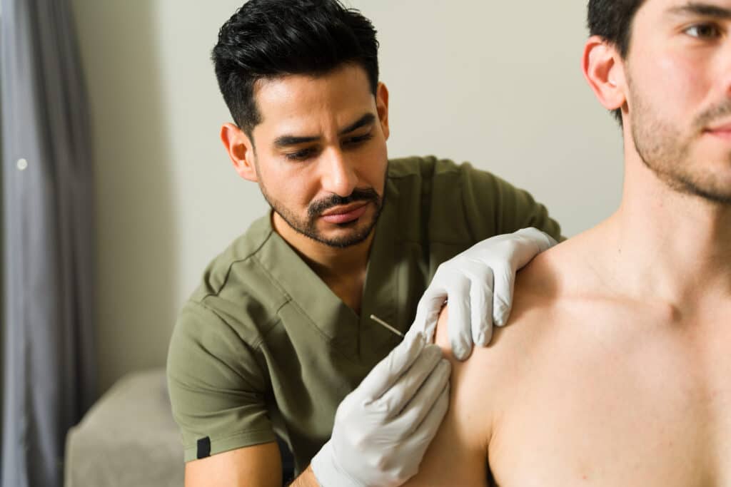 rehab therapist administers dry needling